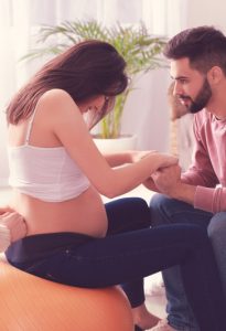 Pregnant couple with doula at home